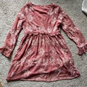 Pink and white vintage floral dress with a V neckline, long sleeves, and ruffles